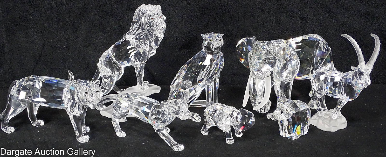 8pcs SWAROVSKI CRYSTAL AFRICAN ANIMALS: Includes: an elephant with tusks, two baby elephants, a lion on a rock, a tiger, a cheetah, a panther and an Ibex on a rock; Measures: 1.5"H x 5"H