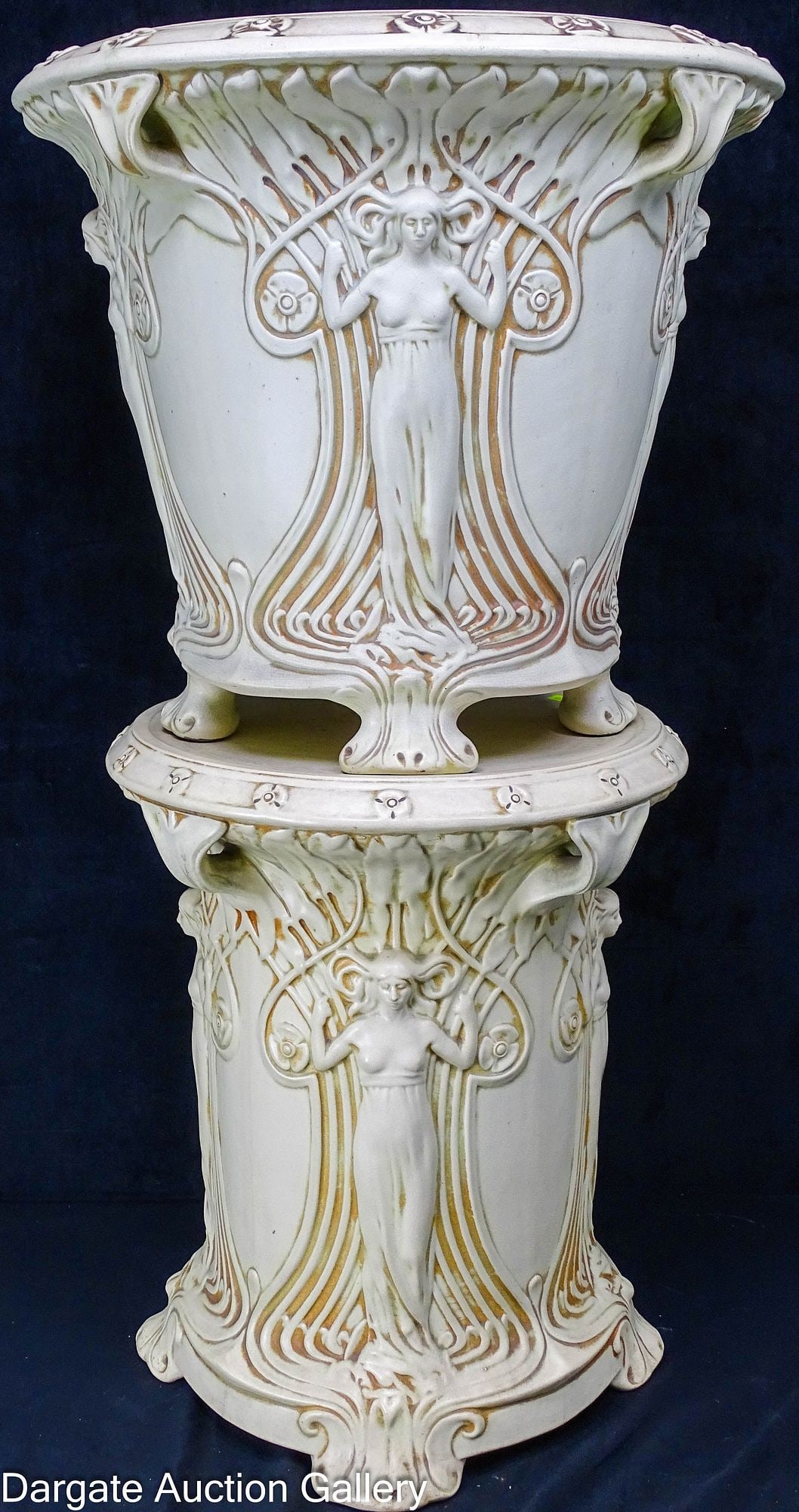 WELLER ART POTTERY IVORY JARDINIERE & PEDESTAL: Weller Art Nouveau pottery "Clinton Ivory" jardiniere and pedestal; decorated with high relief decorations of standing nouveau style maidens with flowing filigree, both jardiniere and