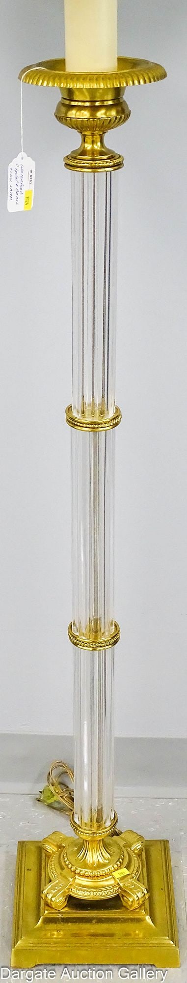 WATERFORD CRYSTAL AND BRASS FLOOR LAMP: A well executed floor lamp with exceptional brass base; 3 fluted crystal column inserts, with brass urn top light with a laurel finial; pleated fabric shade; Measures: Lamp - 60"H x 8.25"W x