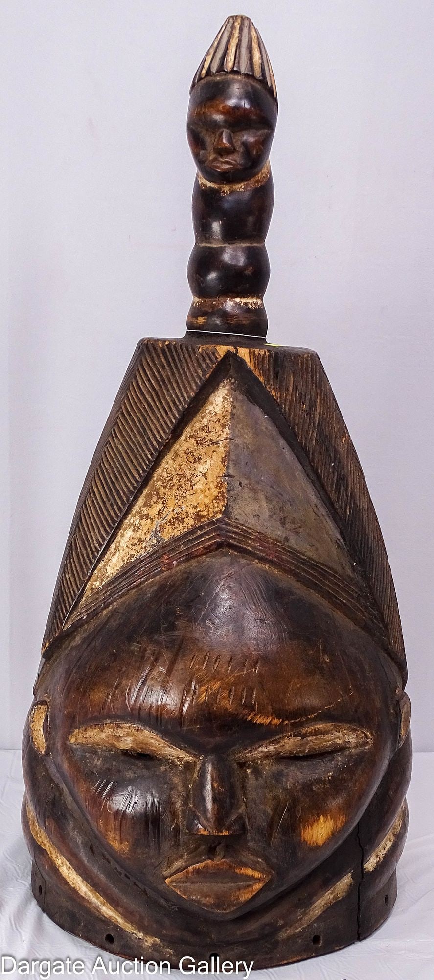 MENDE CARVED WOOD HELMET MASK: A hand-carved wooden helmet mask from the Mende and Sherbro peoples of Sierra Leone and Liberia. Known as a Sowei mask, it was used by the exclusively female Sande society during initiation ceremonies