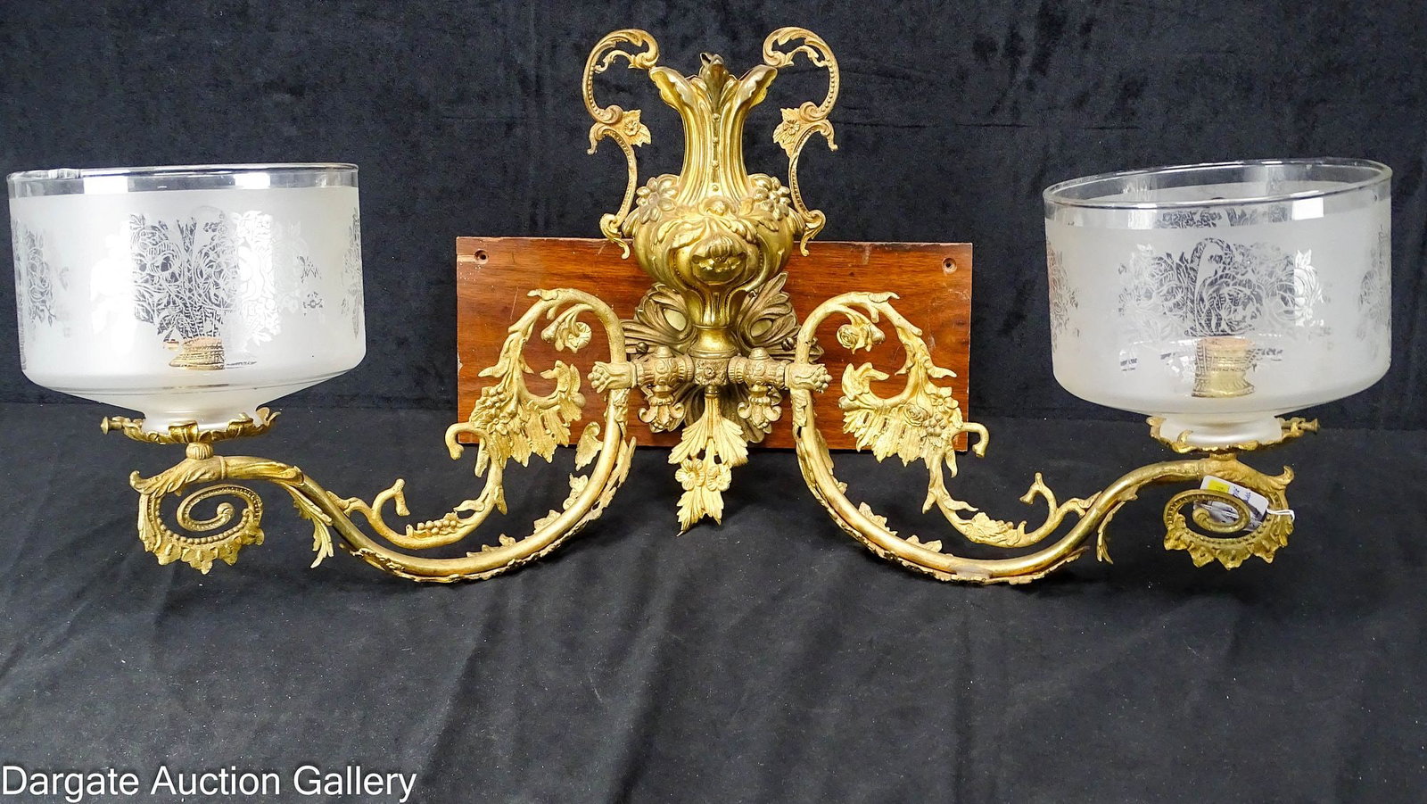 FRENCH ROCOCO STYLE 2-LIGHT WALL SCONCE: 19th Century Louis XV French wall sconce, made of gilt bronze with ornate floral and leaf scroll work, featuring a 2-handle urn in the middle; Originally a gas light that has been electrified; cylinde