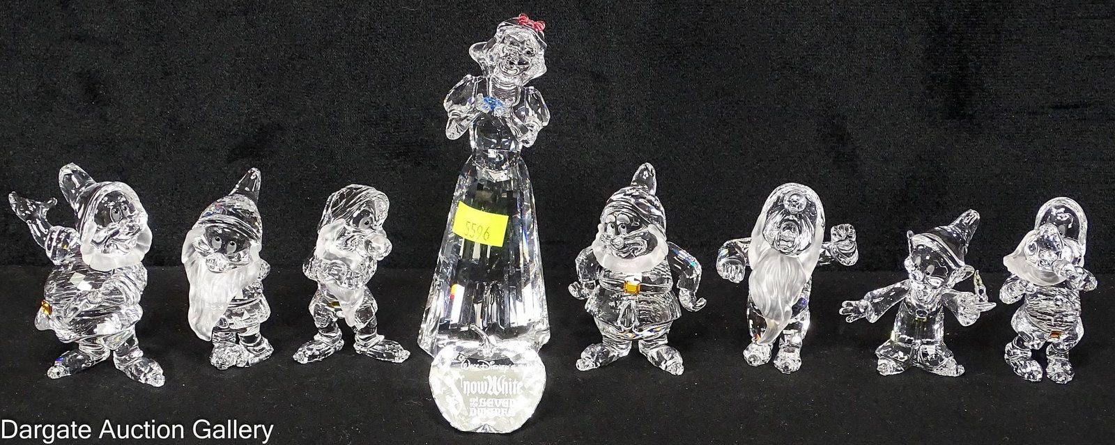 9pcs SWAROVSKI CRYSTAL SNOW WHITE AND THE SEVEN DWARVES: A 9pc set of Walt Disney's Snow White and the Seven Dwarves in Swarovski Crystal; Includes: Snow White holding a blue diamond, all seven dwarves, and the crystal apple reading "Walt Disney
