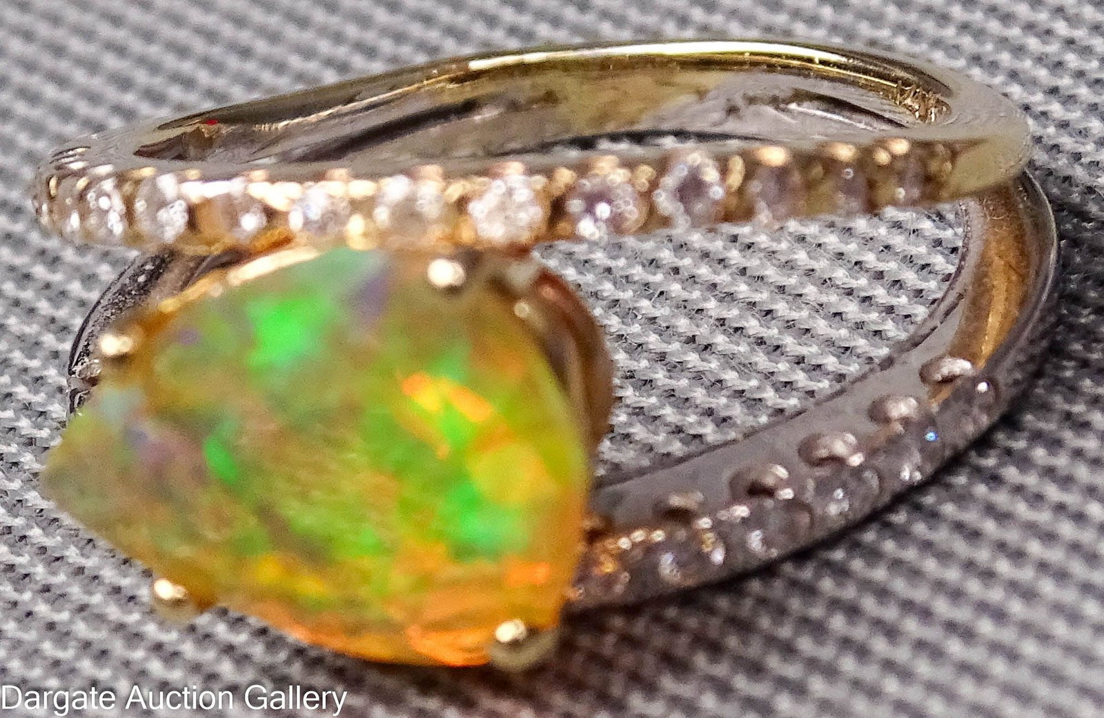 14k ETHIOPIAN OPAL AND DIAMOND RING: Two-tone 14k gold, double band ring, one yellow and one white, each set with small diamond chips, separated at the top by a faceted pear shaped Ethiopian opal [14k]; Size 5, Opal - 11mm x 9mm x 5mm (a