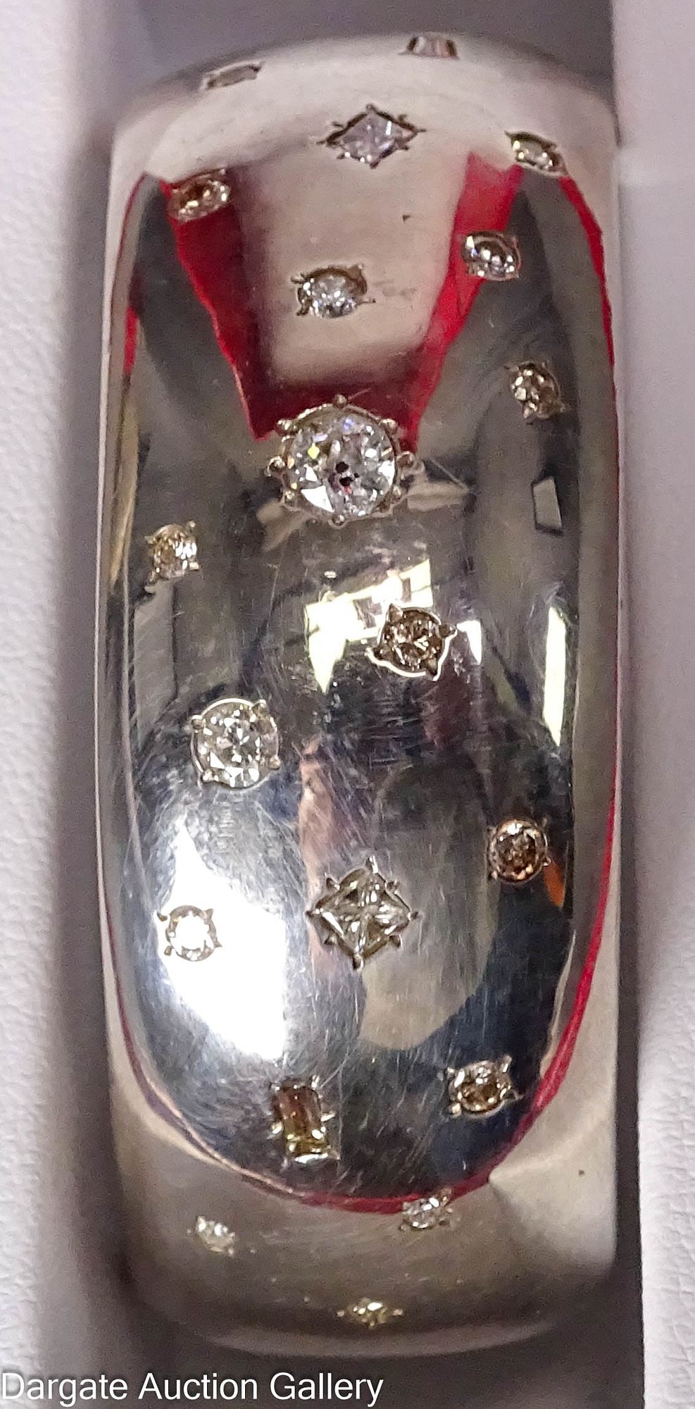 CUFF BRACELET SET WITH DIAMONDS: 1" wide silvertone cuff bracelet, possibly Sterling, but not marked, set with 23 diamonds of different shapes and sizes on the top; Measures - 2" inner width, 1" opening, 49.4g