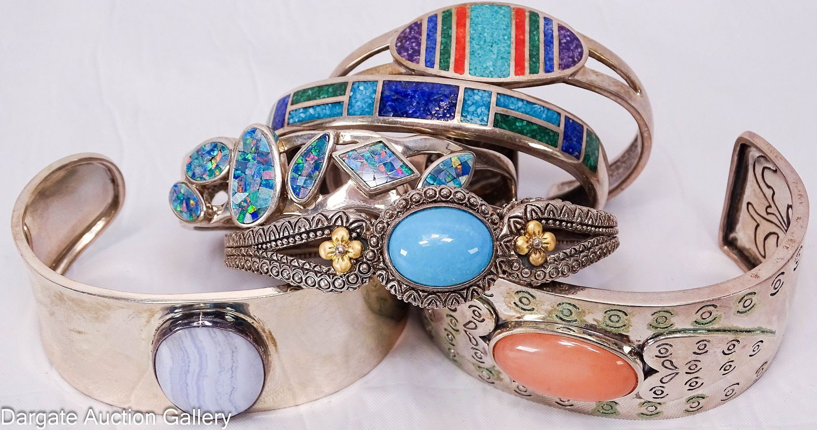 (6) SOUTHWESTERN STERLING CUFF BRACELETS: Includes: Whitney Kelley wide Sterling cuff bracelet, set with an oval pink chalcedony cabochon [WK 925 CHINA], 1 1/8" thick, 2.5" inner width, 59.3g Mexican Sterling wide cuff bracele