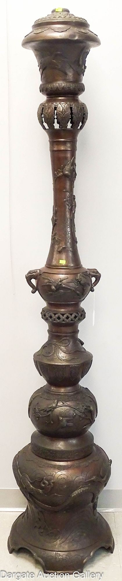 ORIENTAL BRONZE MONUMENTAL FLOOR STANDING OIL LAMP: A monumental oriental bronze oil lamp that was converted to electric. Electrical components are missing, but original font was drilled for wiring. Lamp is sectional and will come apart for easy moving
