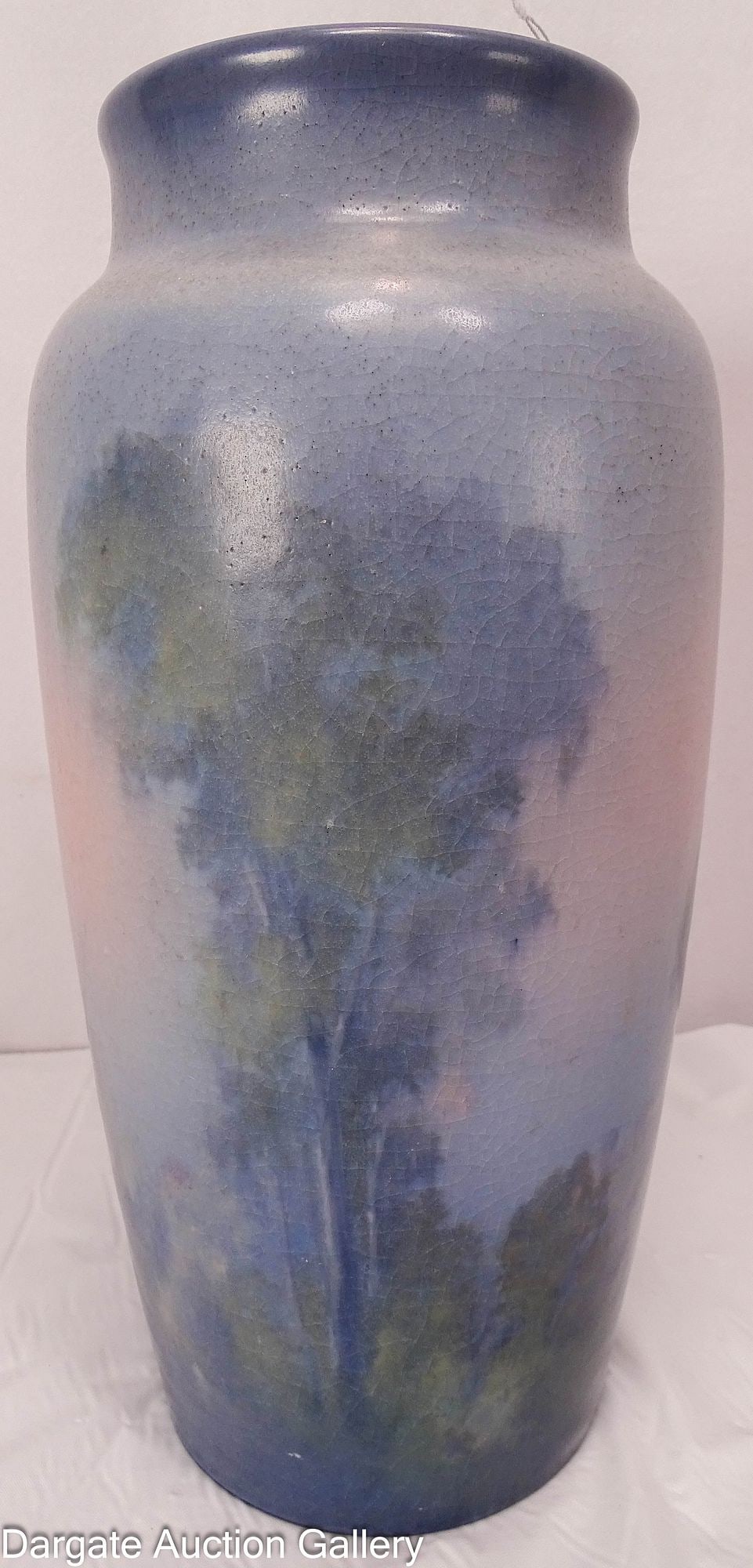 1915 ROOKWOOD SCENIC VELLUM ED DIERS: A Rookwood woodland scene vellum vase, dated 1915, by Edward Diers, who worked for Rookwood from 1896 until 1931. Bottom has the Rookwood logo and date letters for 1915, shape 1065B, V for Vellum and