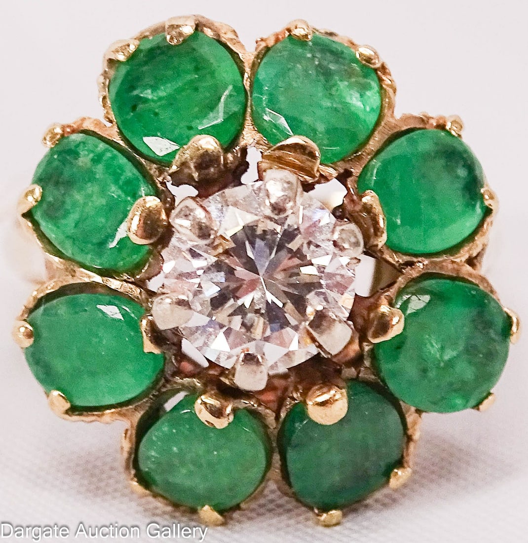 14k YELLOW GOLD 1 ct DIAMOND AND EMERALD COCKTAIL RING: 14k yellow gold ring with diamond and emeralds in a floral pattern. Central round cut diamond (approx 1ct) surrounded by (8) oval cut natural emeralds (Approx 0.85 ct each, 6.8 cttw), marked [14k