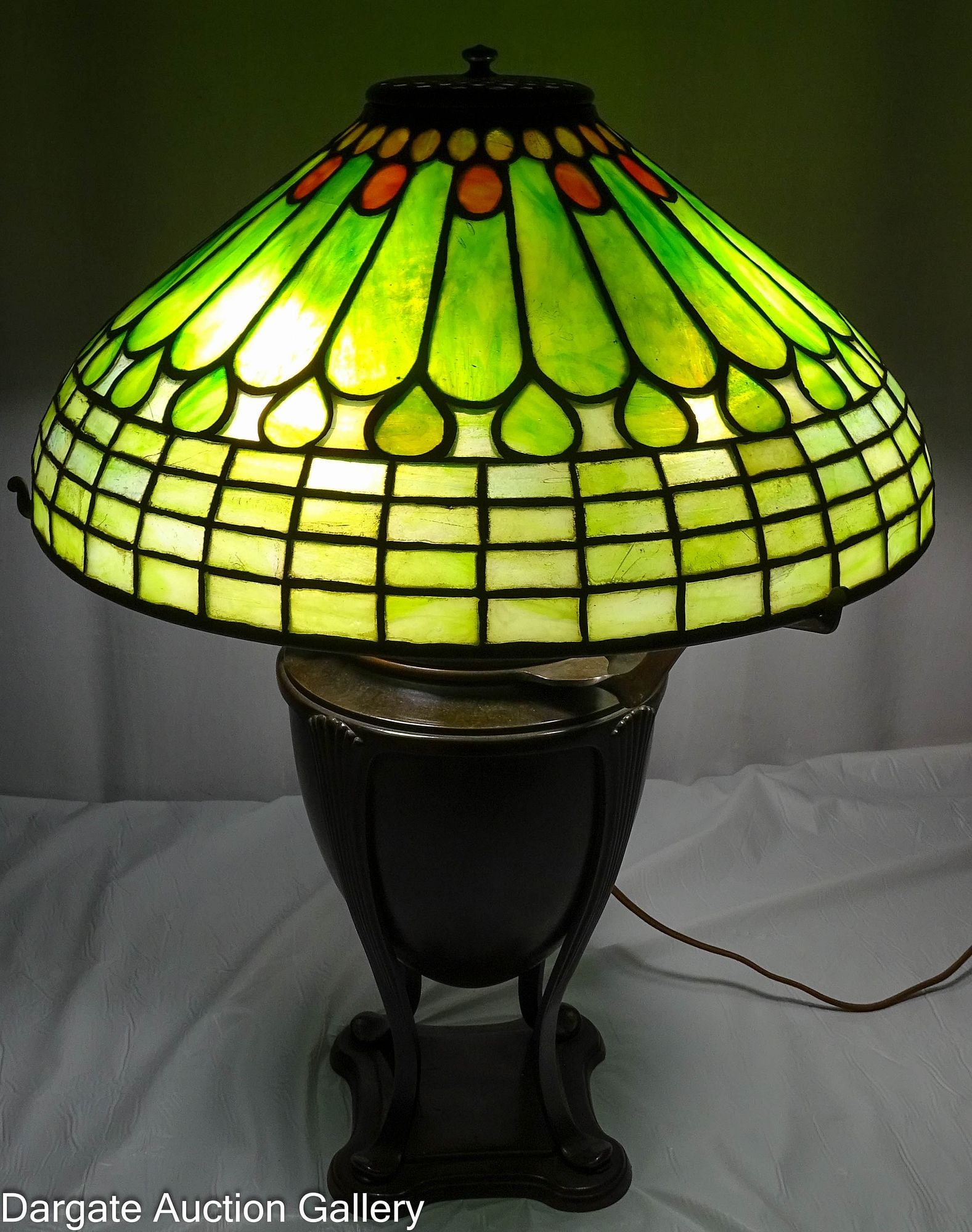 TIFFANY SIGNED LEADED GLASS FEATHER SHADE LAMP: Circa late 19th to early 20th Century; Signed Tiffany base and shade; Base is signed on the bottom of the font, shade is signed on the inside bottom came rim [TIFFANY STUDIOS NY]; Roman or Greek urn