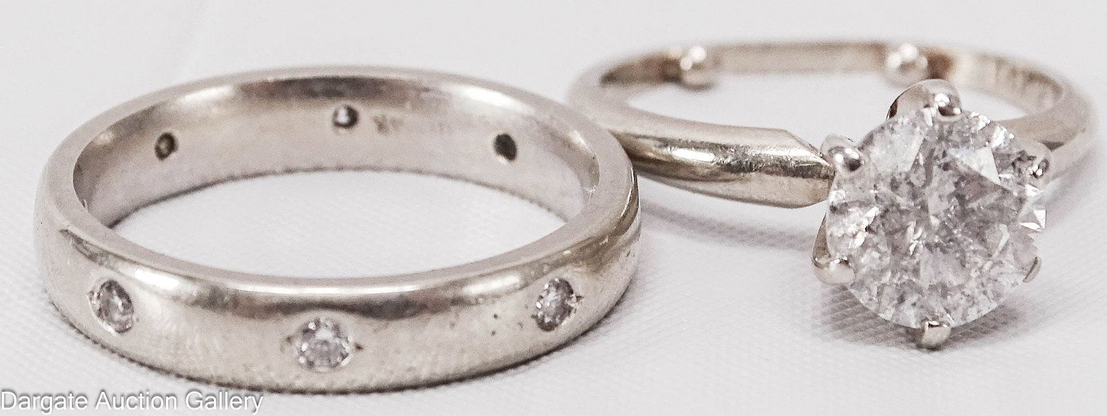 2pc 14k WHITE GOLD 1.3 ct DIAMOND WEDDING RING SET: Engagement Ring - 14k white gold set with round cut solitaire (approx. 7mm x 4mm, 1.3 ct), size 5 (with sizer); Wedding Band - 14k white gold set with 8 small diamonds, size 6; Total Gross Weight -