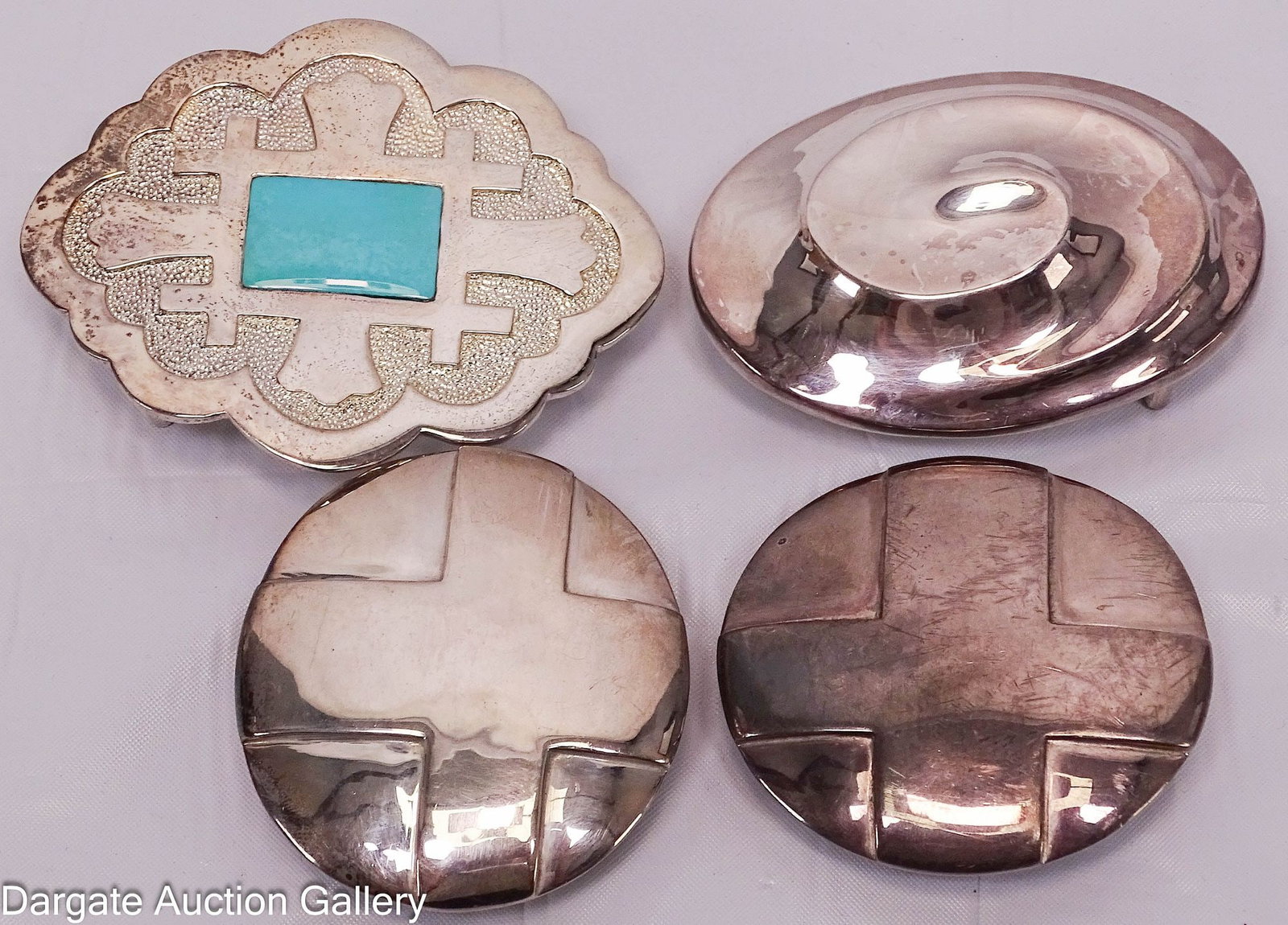 (4) ROBERT LEE MORRIS STUDIO STERLING BELT BUCKLES: All pieces marked [RLM STUDIO 925] Includes: Set with turquoise, 2.25"H x 3"W, TGW - 51.7g (2) Cross buckles, 2" diameter, 90.5g (combined) Swirled Design, 1.75"H x 2.5"