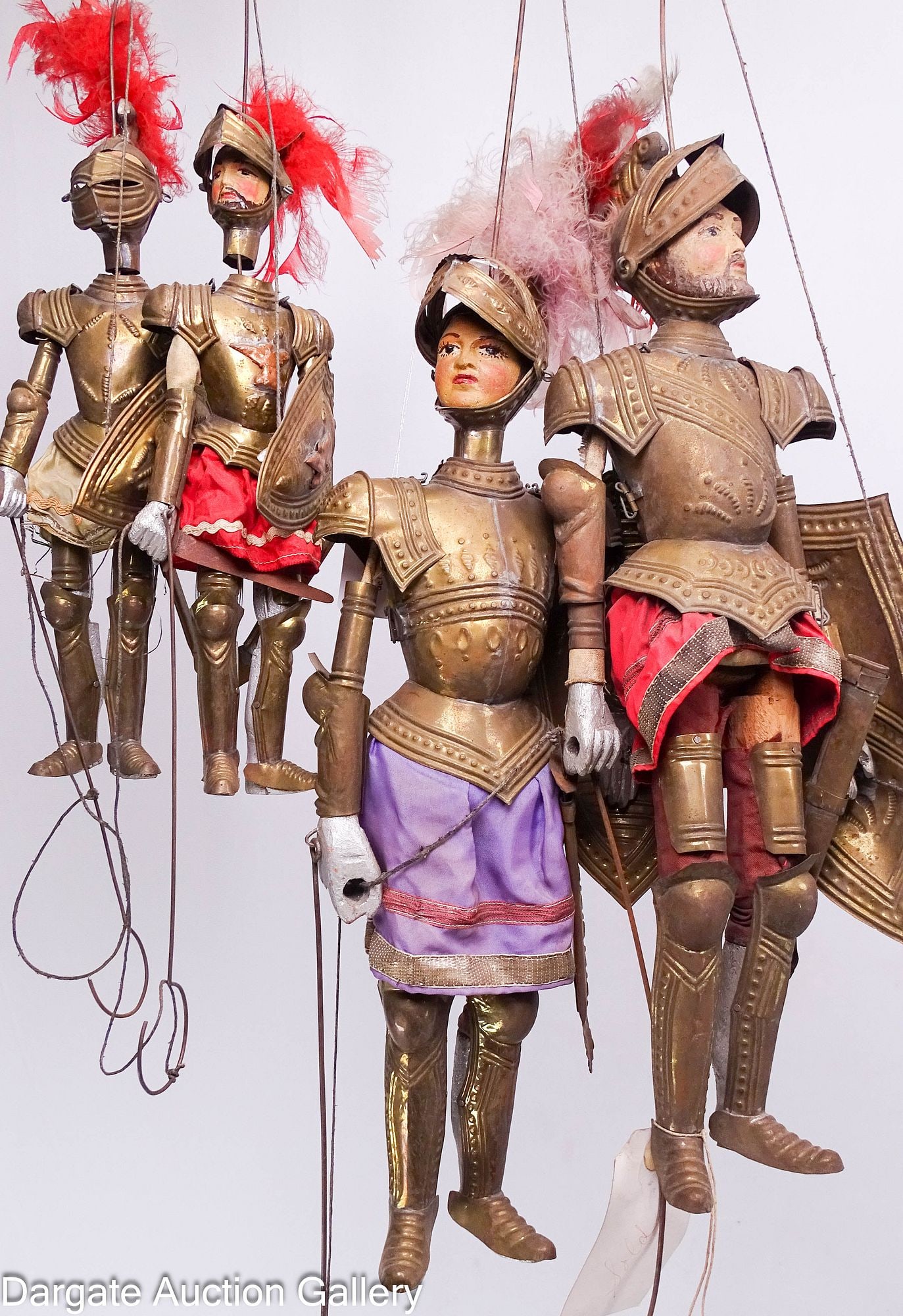 (2) PAIRS OF SICILIAN MARIONETTES OPERA DEI PUPI: Two pairs of Sicilian puppet theater "Opera dei Pupi" medieval knight marionettes. Each is crafted from painted wood and features punched brass suits of armor with cloth and feather accents.