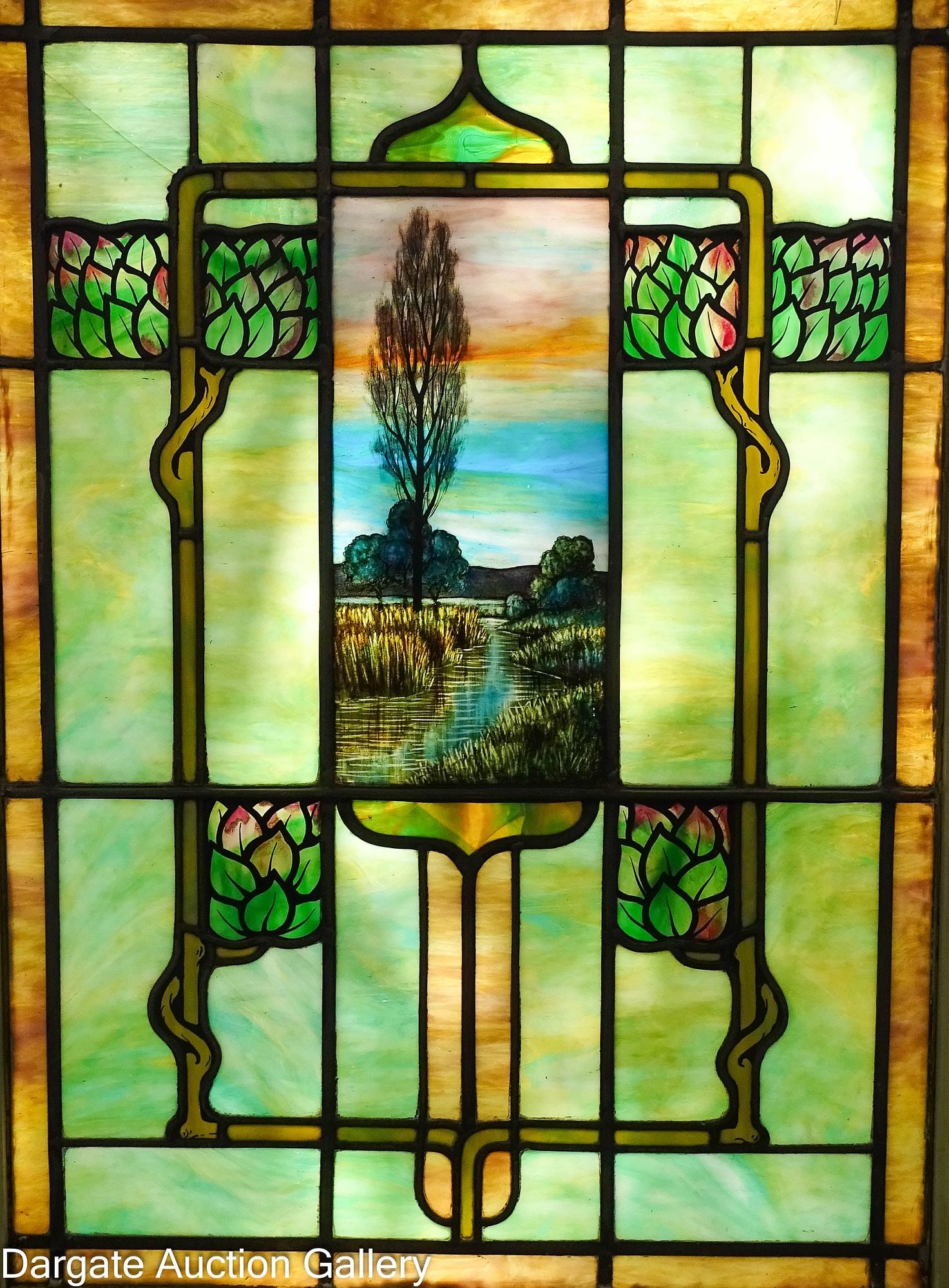 ART NOUVEAU STYLE STAIN GLASS WINDOW: Late 19th - Early 20th Century; Stain glass window with a landscape scene depicting a tree near a stream in the center panel; this is flanked on either side with stylized trees with painted leaves