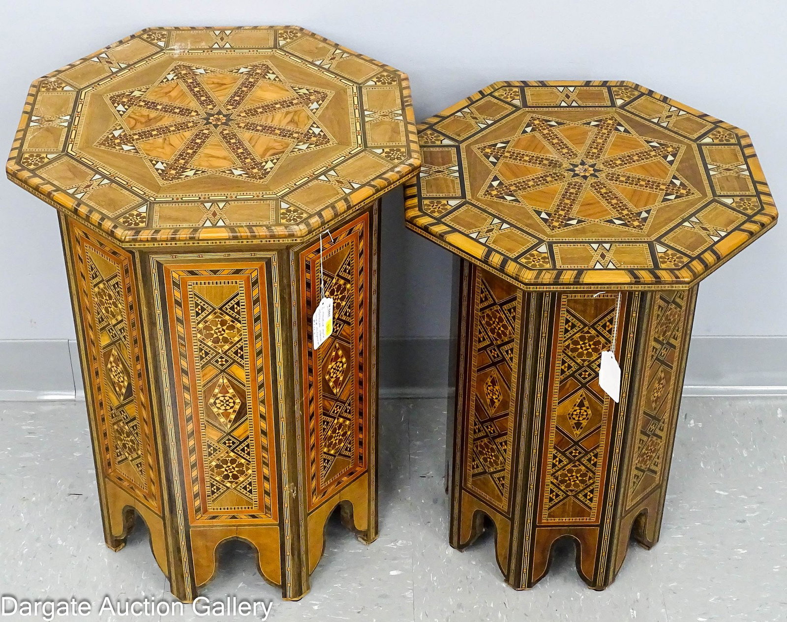 (2) MOORISH MOROCCAN STYLE STANDS: (2) Octagonal Moroccan style stands with mother of pearl inlay and intricately done inly in a variety of woods; Measures: Small - 21"H x 16.5"D (Made in Syria), Large - 23"H x