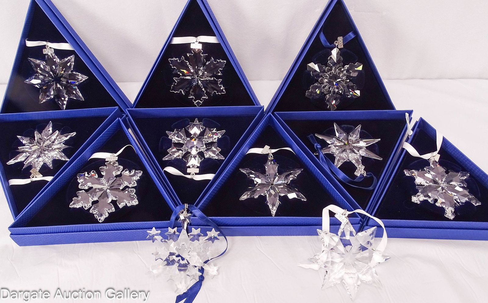 (11) ASSORTED SWAROVSKI CRYSTAL CHRISTMAS ORNAMENTS 2004-2016: Includes: (9) 2008-2016 all in original boxes; (2) 2004 & 2013 do not have their original box; Measures: 6.25" triangular boxes