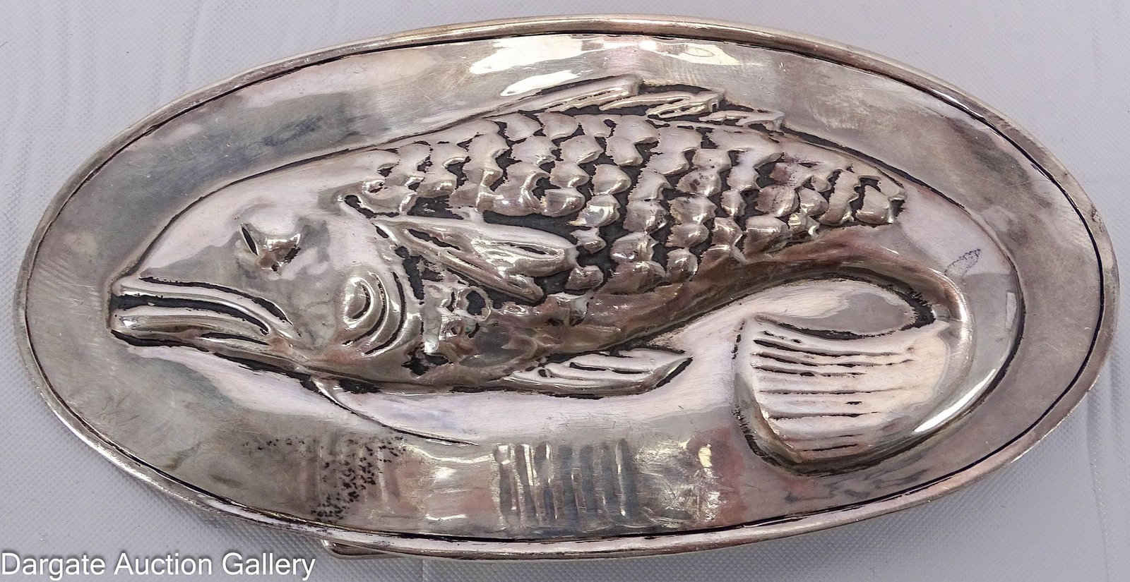 LYN GAYLORD STERLING BELT BUCKLE: Lyn Gaylord, of Western Connecticut, sterling belt buckle of a fish in relief; 2"H x 4"W, 73.1g [LYN GAYLORD] [925]