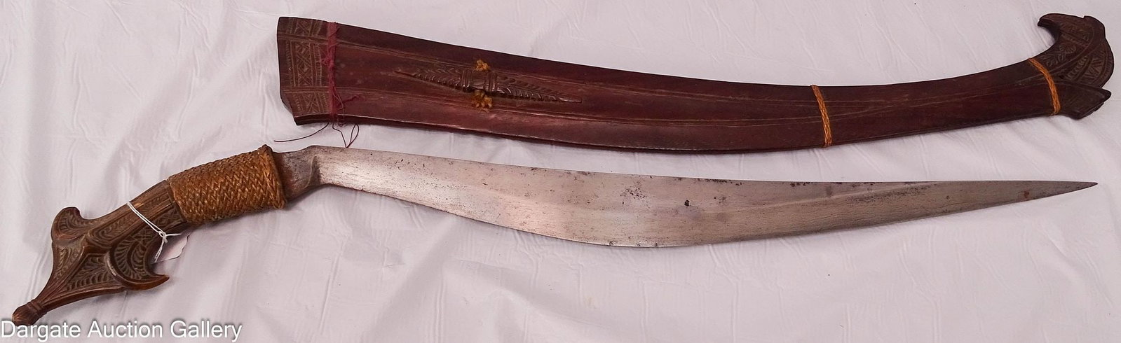 FILIPINO PINOY TALIBONG BOLO SWORD: Philippine Talibong bolo sword with carved wooden scabbard. The sword has a heavy forged iron single-edge blade with a carved wooden hilt with a woven fiber cover. The scabbard is made of mahogany or 