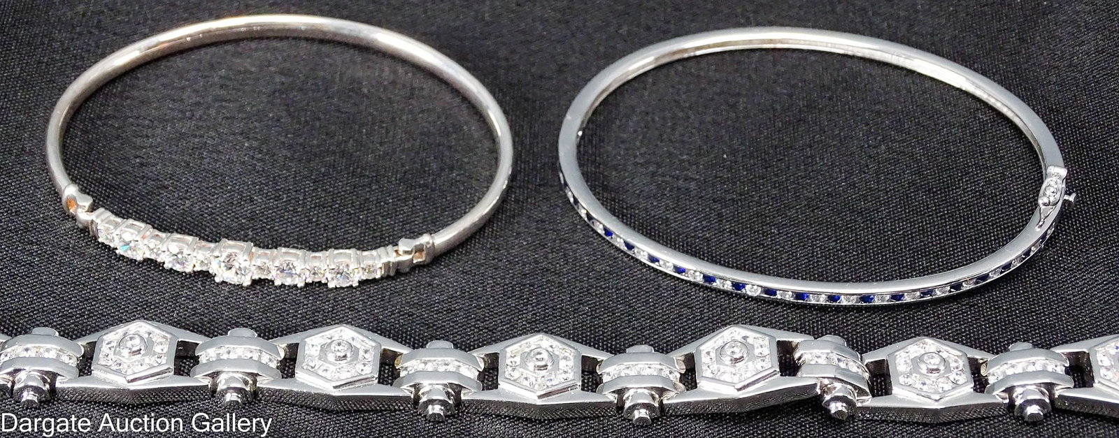 (3) STERLING AND CUBIC ZIRCONIA BRACELETS: Includes: 8.5"L Sterling & CZ bracelets [925] 52.9g Sterling & CZ bangle bracelet with hinged hook closure [925] 2.5"W, 9.9g Sterling & CZ bangle bracelet with hinge box cl