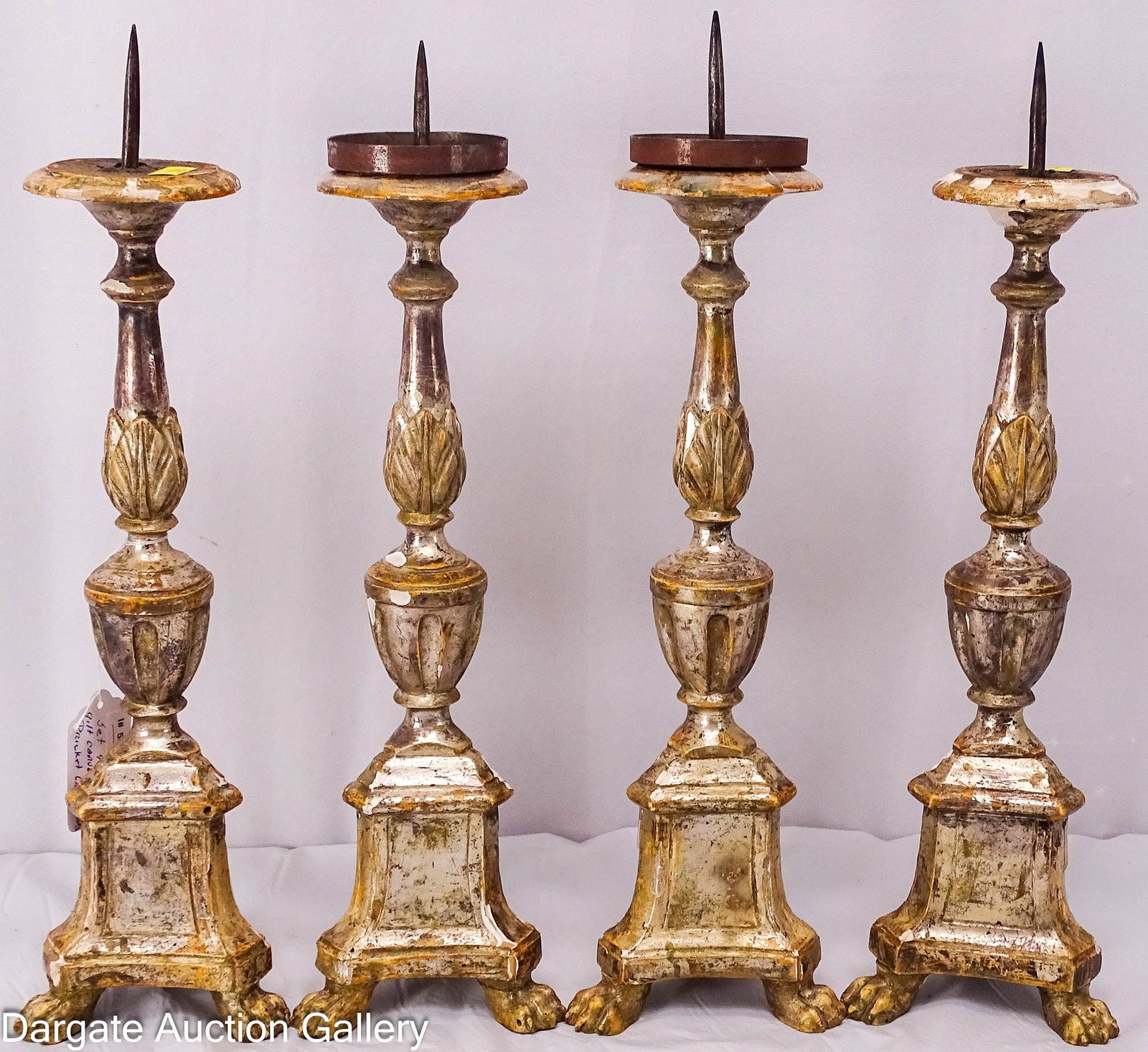 4pcs SET CONTINENTAL SILVER GILT PRICET CANDLESTICKS: A set of 4 carved silver gilt wood candlesticks with paw feet; Measures: 16"H to spike x 13.5"W to wood; Condition: 2 missing metal base liners, considerable wear, chips, soiling