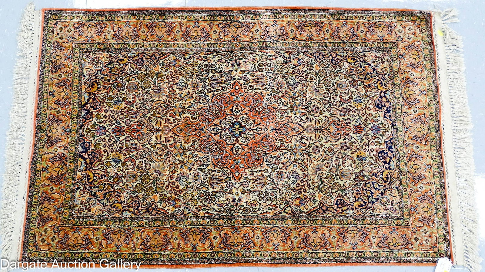 PERSIAN HASHAN RUG: A hand-knotted Persian Kashan rug, with some silk content, in muted shades of rust, black, green and blue; Measures: 48" x 30" ; Condition - Slight wear
