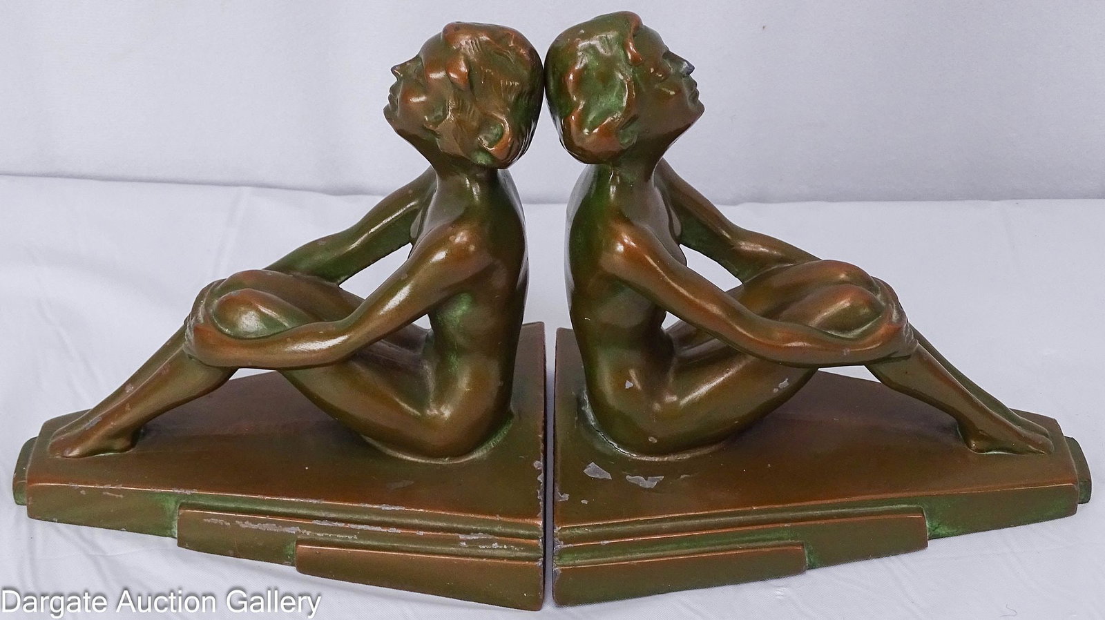 PAIR NUART CREATIONS ART DECO NUDE BOOKENDS: Pair of patinated bronze metal Art Deco seated nude bookends, marked [Nuart Creations NYC], circa 1920-1930's, Frank Art Style; Measures: 5.25"H x 5.75"W x 4"D; Condition: Soiling, 