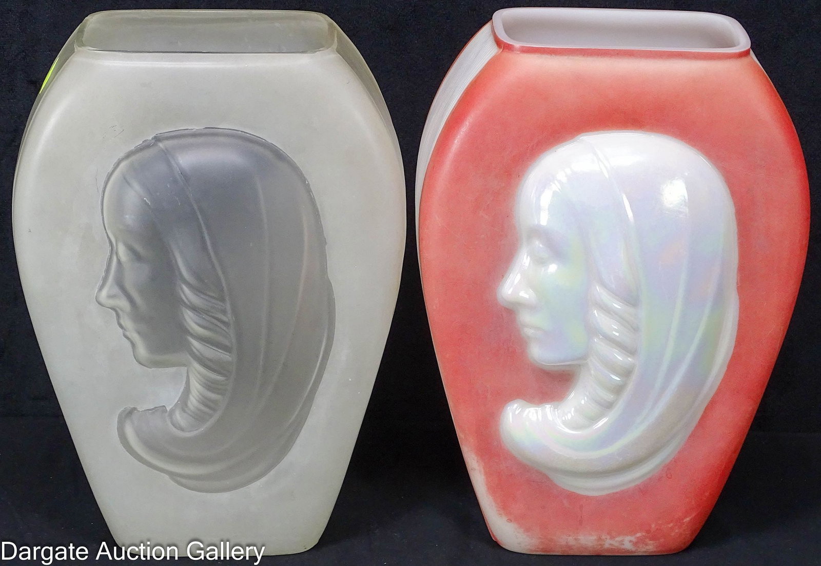 PAIR PHOENIX CONSOLIDATED MADONNA VASES: Includes a pearlescent Madonna head vase with a fired-on mauve background and a two-tone satin glass Madonna vase; the latter retains a blue and silver foil sticker marked [William C. King] [The Corre