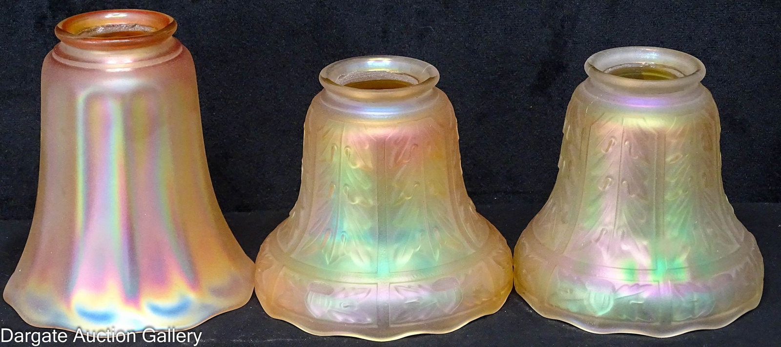 (3) MARIGOLD CARNIVAL GLASS SHADES: All with a 2.25" fitter; Includes: Simple paneled design (5.5"H x 5" diameter) Pair of embossed oak leaf and acorn design (4.5"H x 5" diameter, one showing some fading)