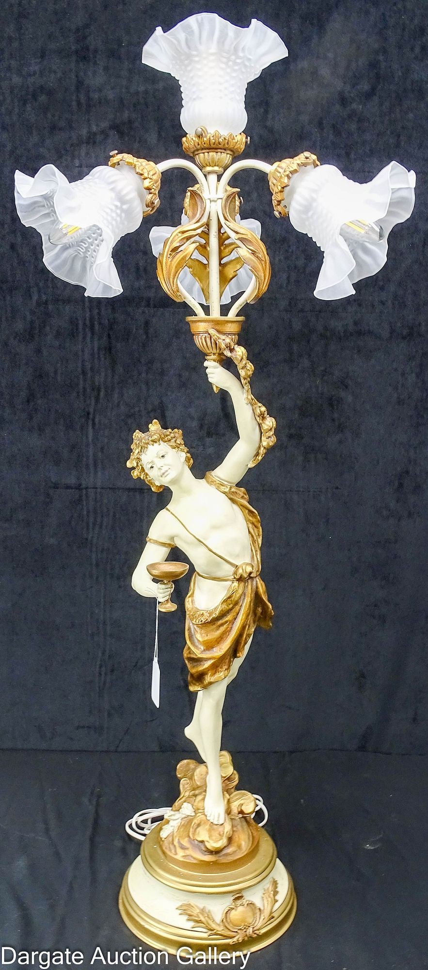 L & F MOREAU FRENCH STYLE TABLE LAMP: A large figural spelter 4-light table lamp of Bacchus holding holding a kylix (chalice) in one hand, and the other holding a torch (with attached lighting), bold painting in a cream and gold finish, (