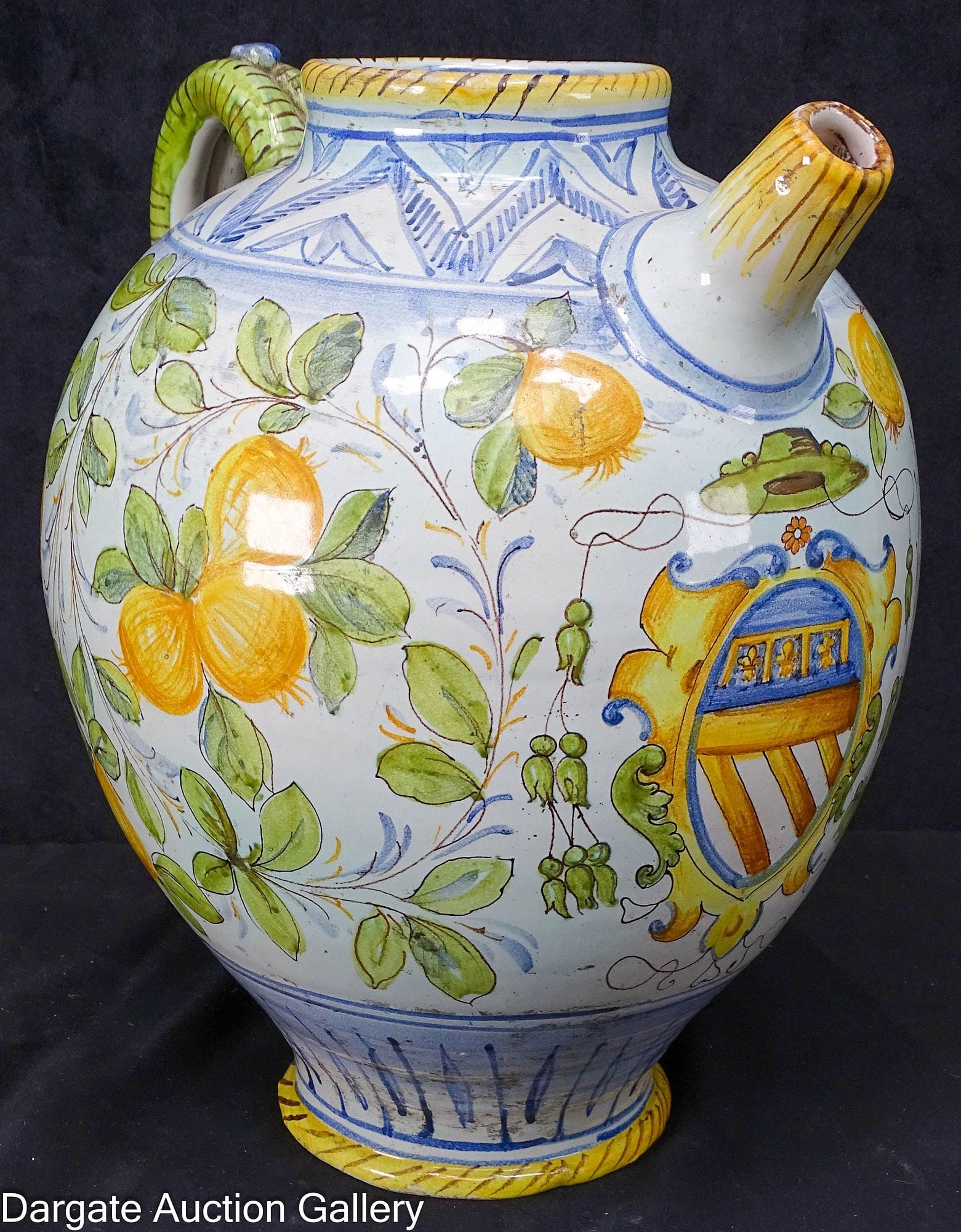 ITALIAN DERUTA POTTERY PITCHER: A hand painted Italian Deruta pottery pitcher of lemons and leaves, with geometric borders; Measures - 13.5"H x x 13"W x 11"D; Condition: Interior has staining in bottom. 