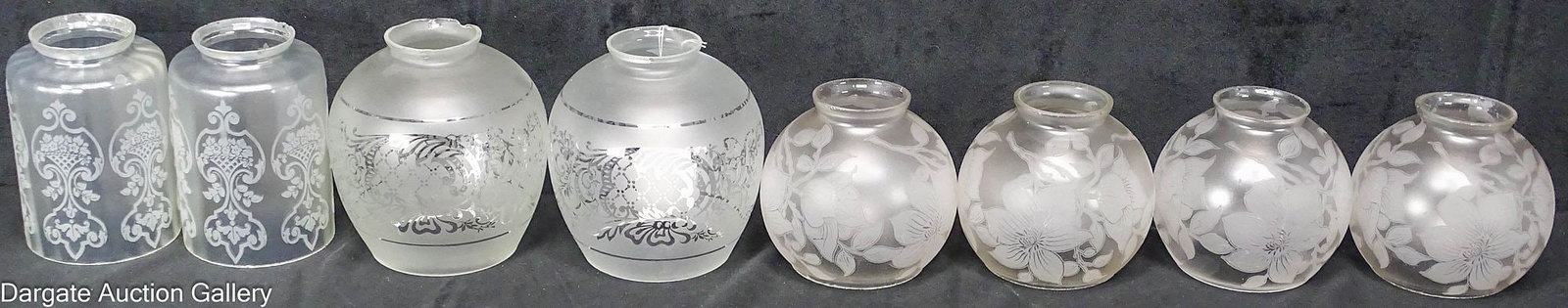 (8) ASSORTED 2.25" FITTER ETCHED GLASS LIGHT SHADES: Includes: A set of 4 ball shaped shades etched with magnolia blossoms - 2.25" fitter, 4"H x 4.5" diameter A Pair of ball shaped shades with an etched scroll design, 2.25"