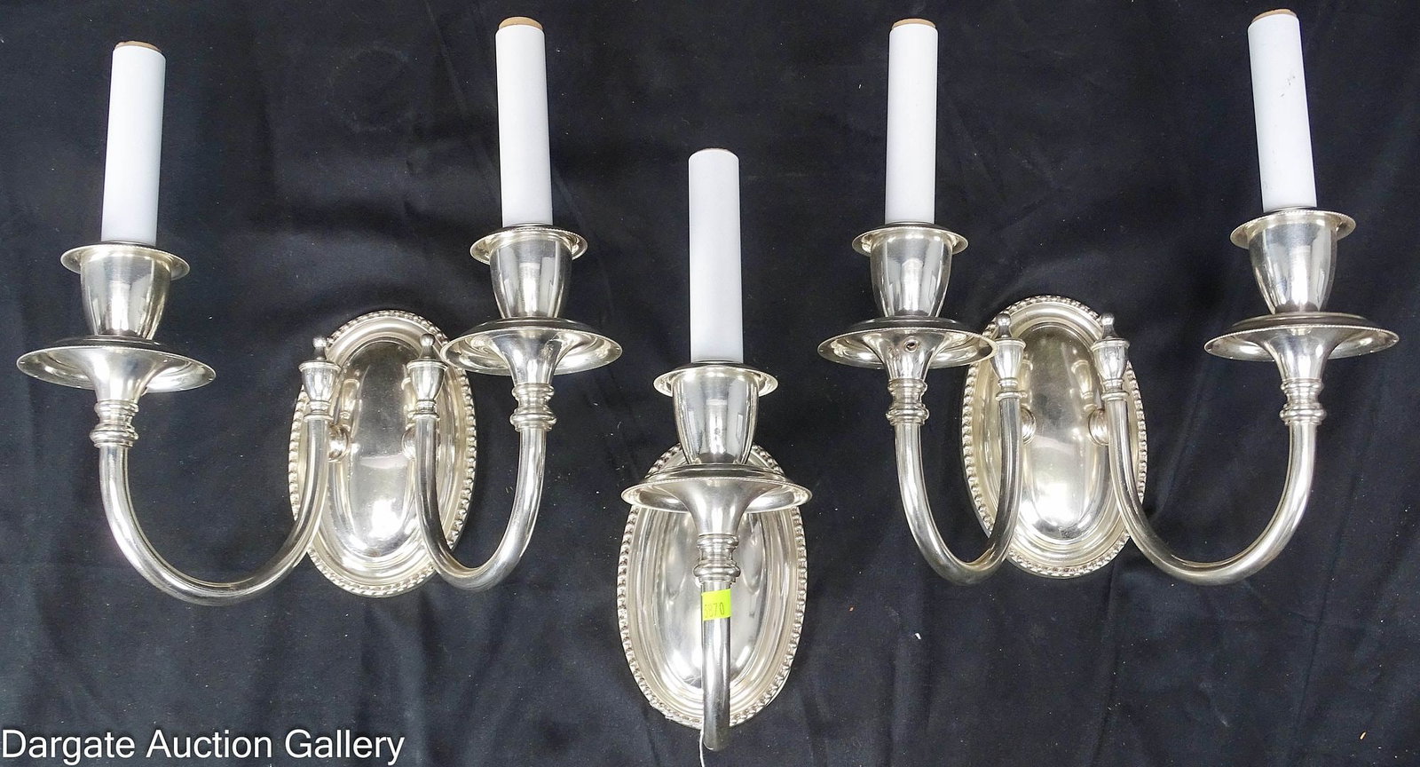 (3) REFURBISHED GEORGIAN STYLE SILVERED SCONCES: Three Georgian style sconces with a silver metallic finish. The set consists of a pair of two-arm sconces and a single one-arm sconce, all featuring white candle covers attached to beaded oval back