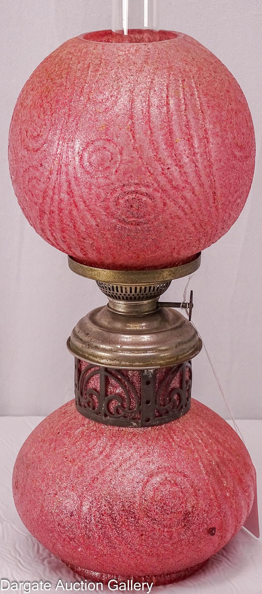 EUROPEAN PINK CORALENE OIL LAMP KOSMOS BRENNER BURNER:: A European oil lamp most likely German or Austrian in an Art Nouveau pattern of swirls and circles; clear glass with pink Coralene decoration, a metal filigree collar on the base, and a drop-in font; 