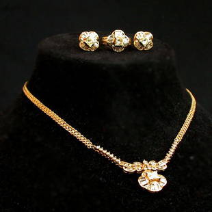 14K DIAMOND SET. Set includes a matchin: 14K DIAMOND SET. Set includes a matching ring, necklace and pierced earrings. The pieces have princess cut center stones surrounded by baguette and round cut diamonds. Total weight of the diamonds is