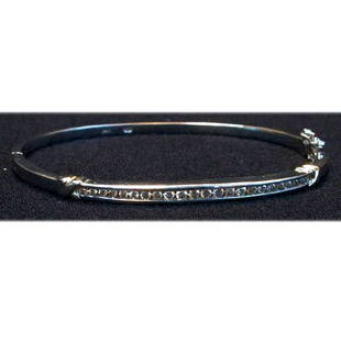14K DIAMOND BANGLE. Gold bangle has a d: 14K DIAMOND BANGLE. Gold bangle has a double row of square cut diamonds. Total diamond weight is approximately 1.0 ct. Total bracelet weight is approximately 13.1 g. Condition: bangle has some