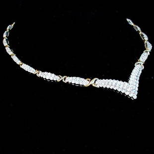 14K DIAMOND CHOKER. The choker style ne: 14K DIAMOND CHOKER. The choker style necklace has round cut diamonds mounted in a white gold setting accented with yellow gold "criss-crosses". Total diamond weight is approximately 7.0 ct. Total