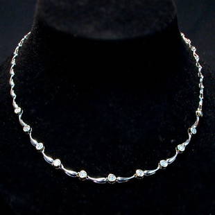 14K DIAMOND NECKLACE. The white gold ne: 14K DIAMOND NECKLACE. The white gold necklace has bezel cut diamonds mounted in yellow gold settings. Total diamond weight is approximately 1.0 ct. Total weight of the piece is approximately 12.6 g.