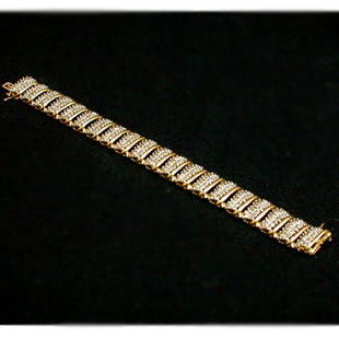10K DIAMOND BRACELET. The bracelet has: 10K DIAMOND BRACELET. The bracelet has round cut diamonds mounted in a yellow gold segmented setting. Total diamond weight is approximately 5.0 ct. Total bracelet weight is approximately 32.2 g.