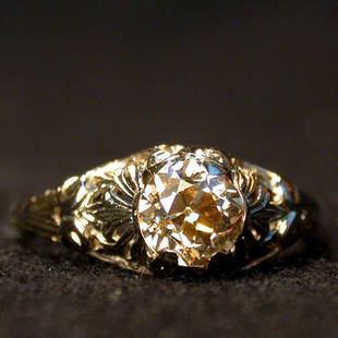 ANTIQUE DIAMOND SOLITAIRE. The yellowis: ANTIQUE DIAMOND SOLITAIRE. The yellowish and light brown mine cut diamond is mounted in an 18K white gold filigree setting. Total diamond weight is approximately .90 plus ct. Condition: no visible