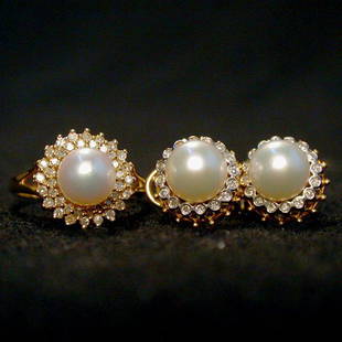 PEARL & DIAMOND RING SET. The set consi: PEARL & DIAMOND RING SET. The set consists of a ring and matching pierced earrings. The white pearls are surrounded by round cut diamonds. Condition: no visible defects.