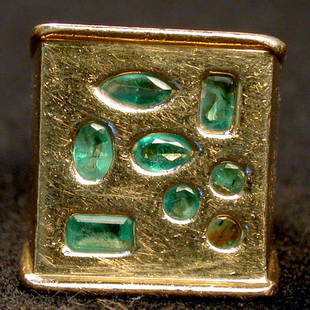 MAN'S 14K EMERALD RING. The custom Arts: MAN'S 14K EMERALD RING. The custom Arts and Crafts style ring has eight emeralds mounted in a yellow gold setting. Condition: some stones are scratched and one is chipped.