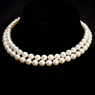 DOUBLE STRAND PEARL NECKLACE. The neckl: DOUBLE STRAND PEARL NECKLACE. The necklace has 93 cultured pearls and one imitation pearl averaging approximately 7.60mm. It has a 14K white gold and blue stone clasp. Necklace length: 16". Comes