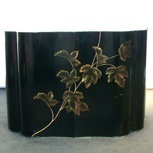 BAKER CO. LACQUERED END TABLE. All four: BAKER CO. LACQUERED END TABLE. All four sides are serpentine. Black lacquered with gilt leaf decoration on one long side and continueing onto the top. Size: 19" H, 21" W, 27" D. Condition: no detracti