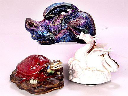 3 DRAGONS. (1) Blue and purple iridescent ceramic: 3 DRAGONS. (1) Blue and purple iridescent ceramic dragon with glass eyes. Marked: Windstone Editions, N. Hollywood. California. Size: 4 1/2''H, 9 1/2''L, 6''W. Condition: good. (1) Ceramic dragon head