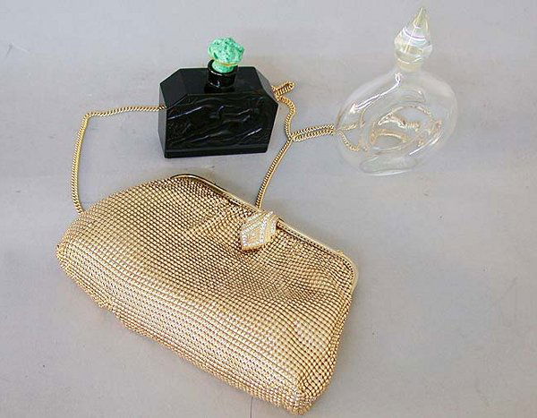 1232 GOLD MESH EVENING BAG AND TWO PERF: 1232 GOLD MESH EVENING BAG AND TWO PERFUME BOTTLES N/R. One perfume bottle is clear glass and stamped "Guerlain, Made in France" on the bottom. The other is black glass with a woman and bird motif eng