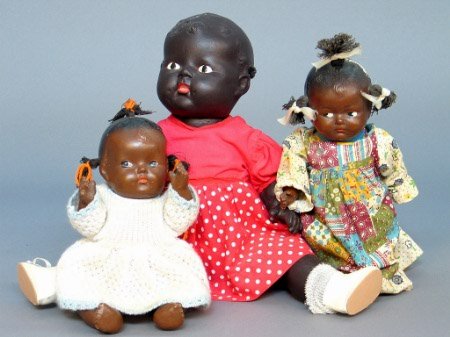 THREE BLACK DOLLS. One is a black baby doll with