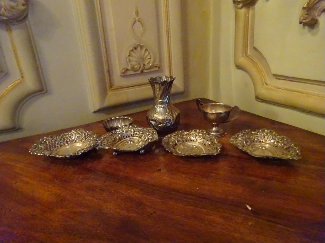 Argenterie: ARGENT - Lot comprenant : Vase dcor rocaille ; Quatre salerons dcor floral et de rubans nous ajours. Coupe sur pidouche. Saleron circulaire. Pinons Anglais et Minerve. Poids brut : 114 g.