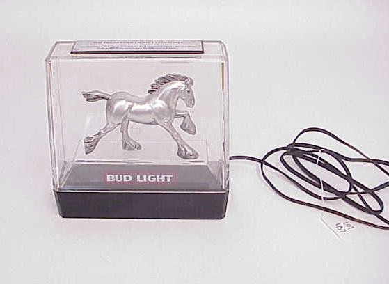 BUD LIGHT CLYDESDALE BUDWEISER ADVERTISING SIGN: Electric advertising Bud Light with silver color Clydesdale figure, plaque on top of clear plastic enclosure. Plugged in, nothing happened, could need bulb? Overall condition good. Shipping weight 5 p