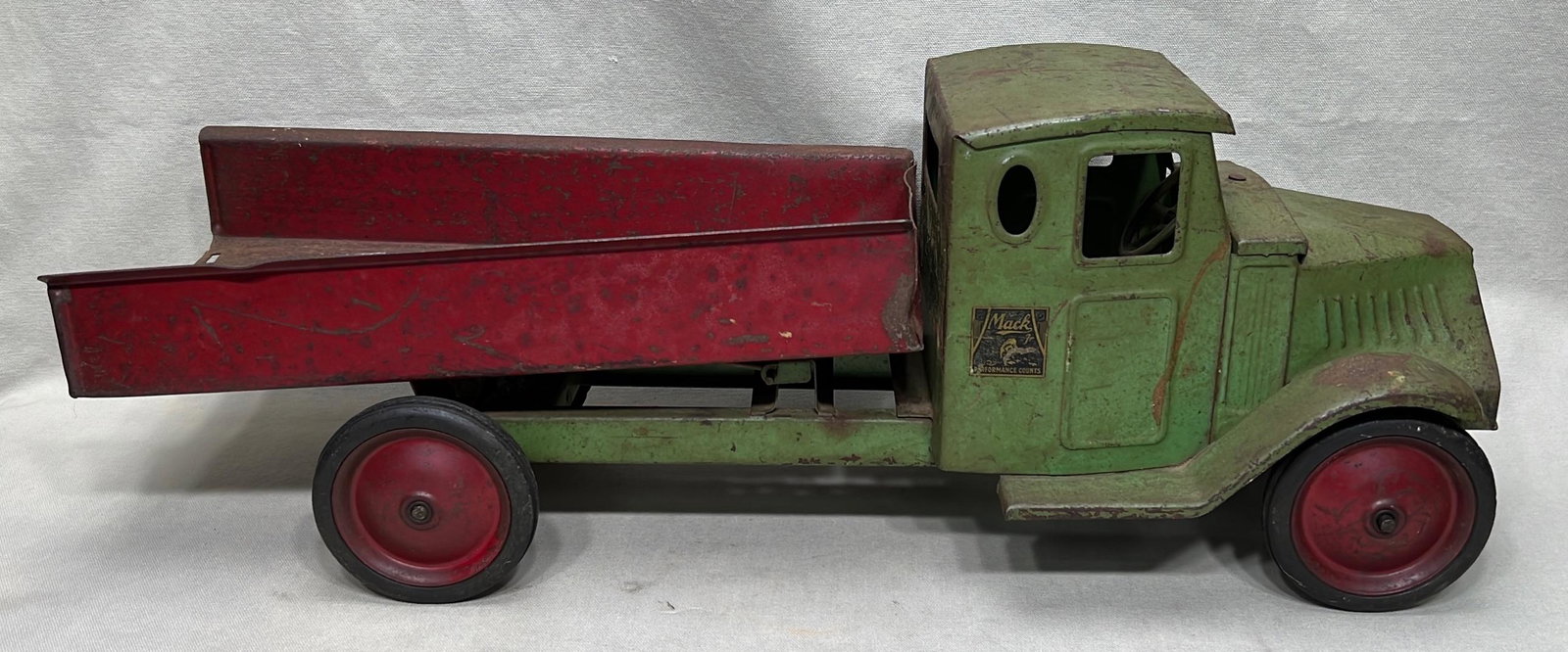 Steelcraft Mack pressed steel dump truck toy: early 20th century, appx. 24" overall length, bed partly detached