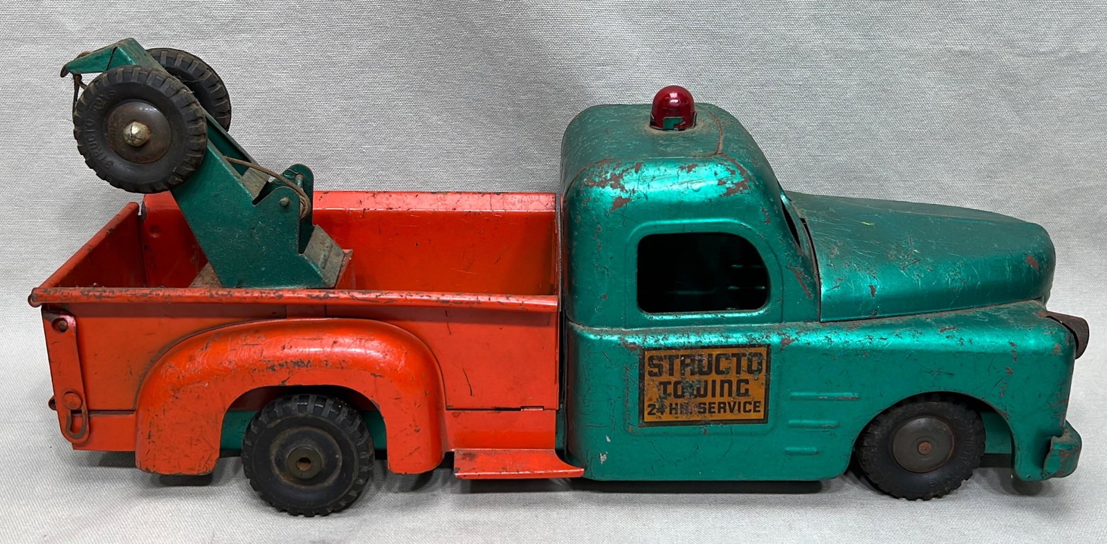 Structo Towing 24 Hr. Service pressed steel tow truck toy: mid 20th century, appx. 17" overall length