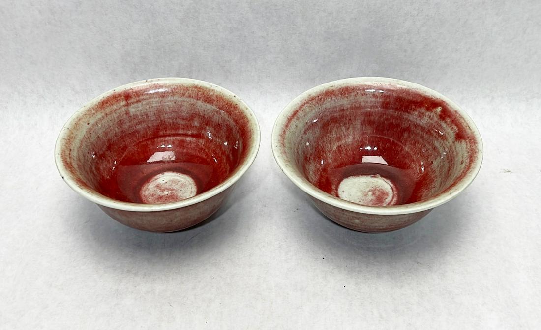 Pair Chinese sang de boeuf porcelain bowls: Double ring mark to underside of each. Tops measure 6 3/16" in diameter.